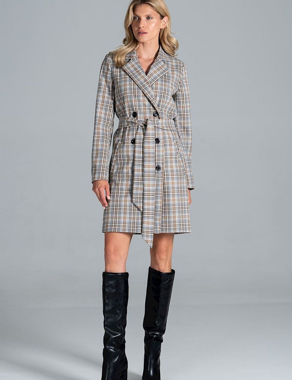 Model wearing Loryndra Belted Knee-Length Autumn Coat with structured collar and matching belt, paired with black knee-high boots.