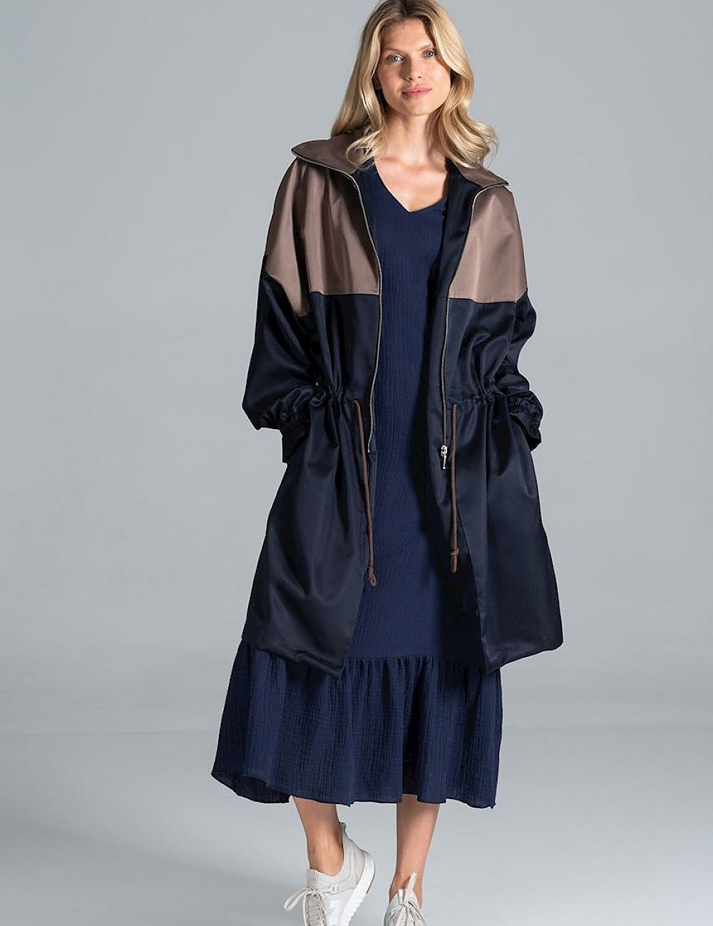 Woman wearing Ardevine two-tone autumn parka coat with relaxed fit, classic collar, and drawstring waist for an adjustable fit.