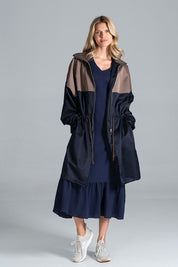 Woman wearing Ardevine two-tone autumn parka coat with relaxed fit, classic collar, and drawstring waist for an adjustable fit.