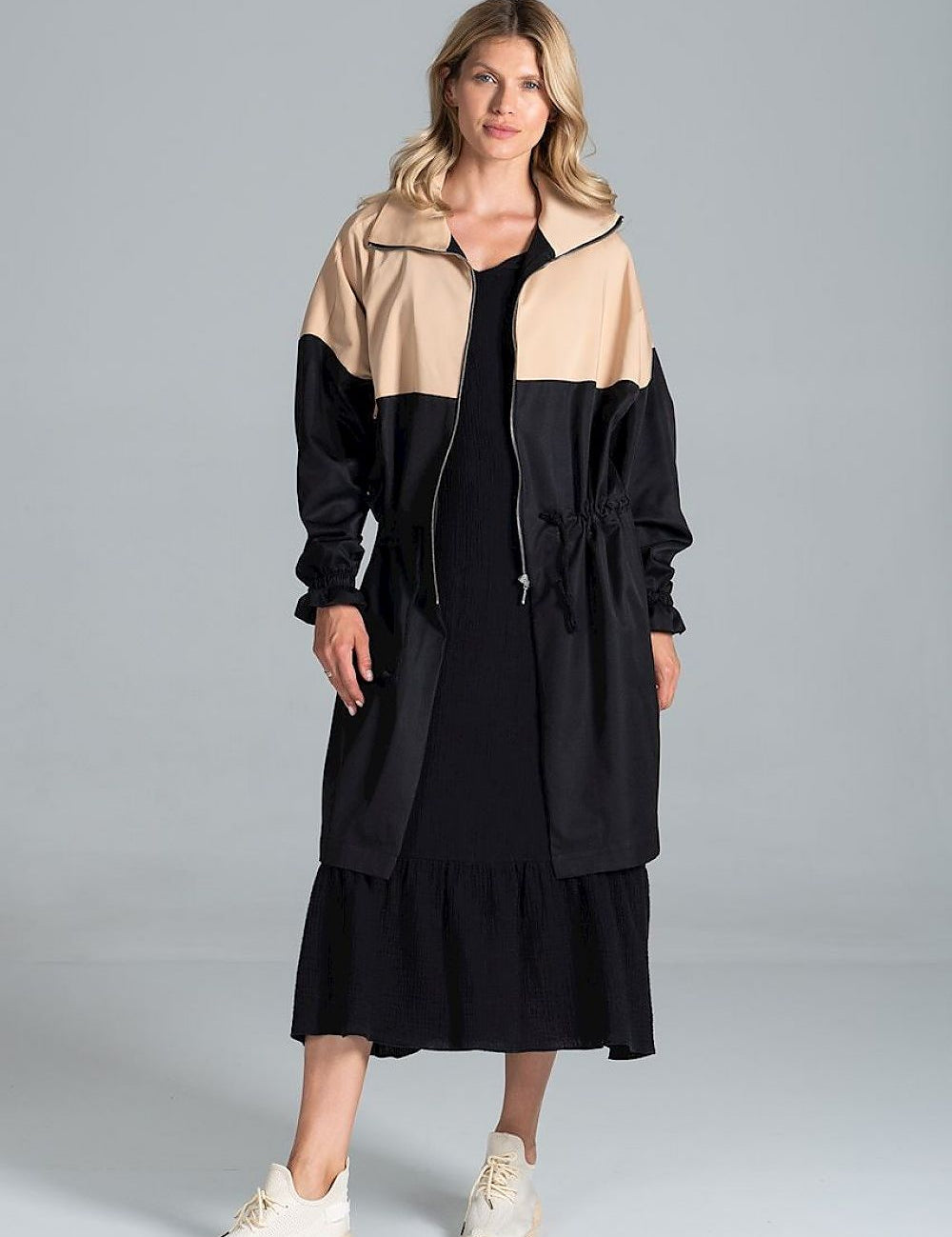 Woman wearing Ardevine two-tone autumn parka coat with relaxed cut and drawstring waist, styled for casual fall look.