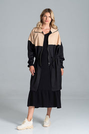 Woman wearing Ardevine two-tone autumn parka coat with relaxed cut and drawstring waist, styled for casual fall look.