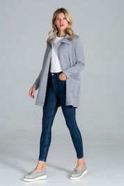 Woman wearing Dervelle short quilted belted coat in light gray, styled casually with jeans and sneakers, showcasing relaxed drape.