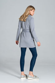 Woman wearing Dervelle short quilted belted coat with classic collar and patch pockets, styled with jeans and loafers.