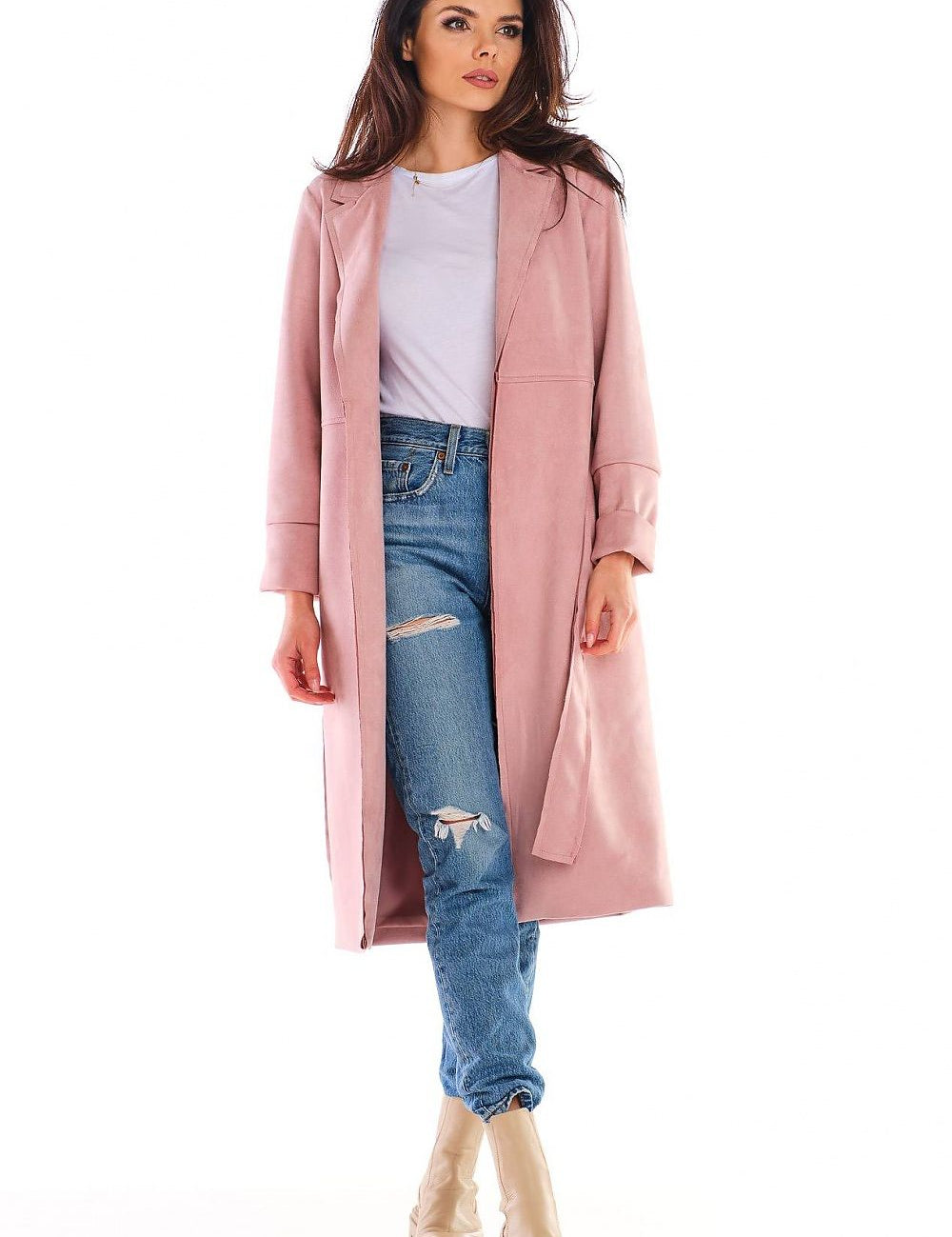 Woman wearing Sylverine Suede Belted Dressing Gown Coat in pink, paired with jeans and boots, showcasing its elegant, versatile design.