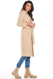 Model wearing Sylverine suede belted dressing gown coat, beige, side view, paired with blue jeans and beige boots.
