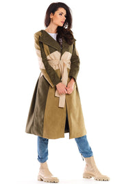 Woman wearing Auralenne long suede belted coat in autumn tones, showcasing an elegant, relaxed fit on a casual city stroll.