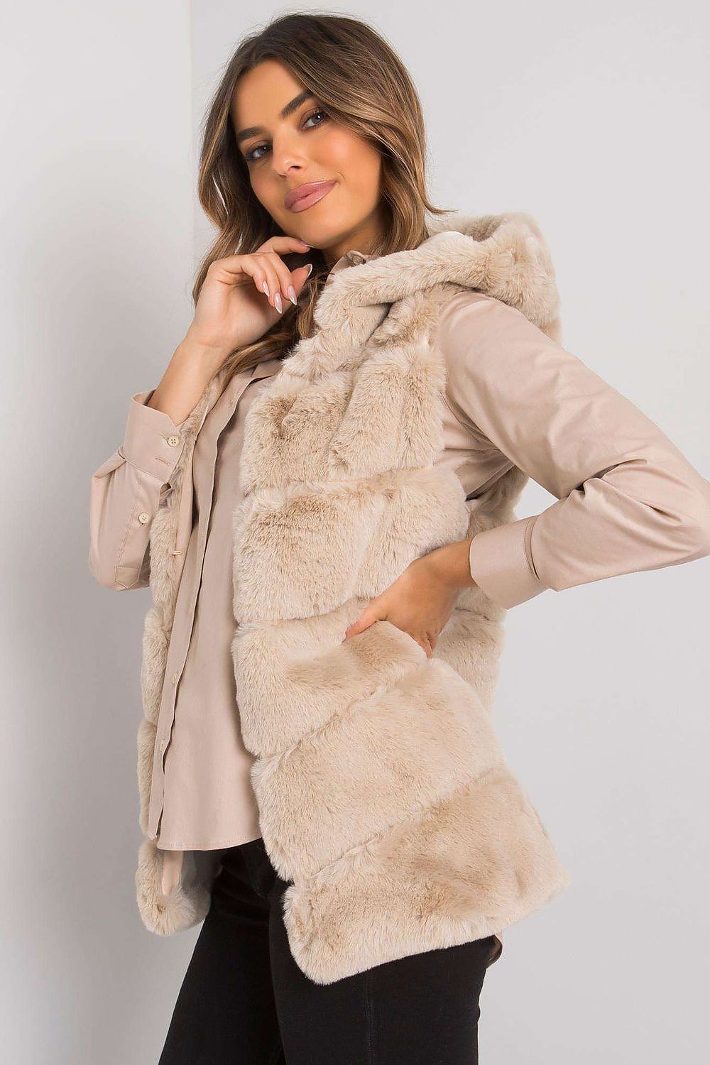 Woman wearing a beige hooded quilted gilet vest, showcasing a stylish and cozy look for versatile layering in changing seasons.