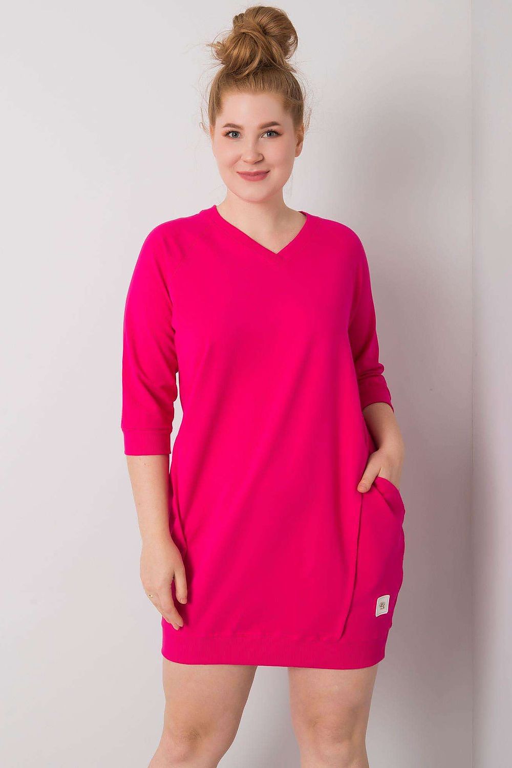 Plus size Velissia cotton pocket dress in vibrant pink with 3/4 sleeves and side pockets, showcasing a relaxed and stylish fit.