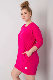 Woman wearing a plus size pink Velissia Cotton Pocket Dress with 3/4 sleeves, highlighting comfortable fit and practical side pockets.