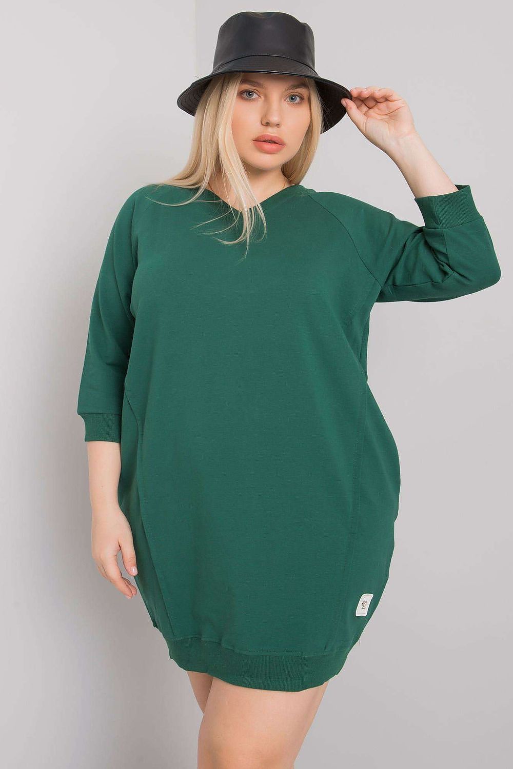 Model wearing Plus Size Velissia Cotton Pocket Dress with 3/4 sleeves, showcasing classic silhouette and side pockets, green color.