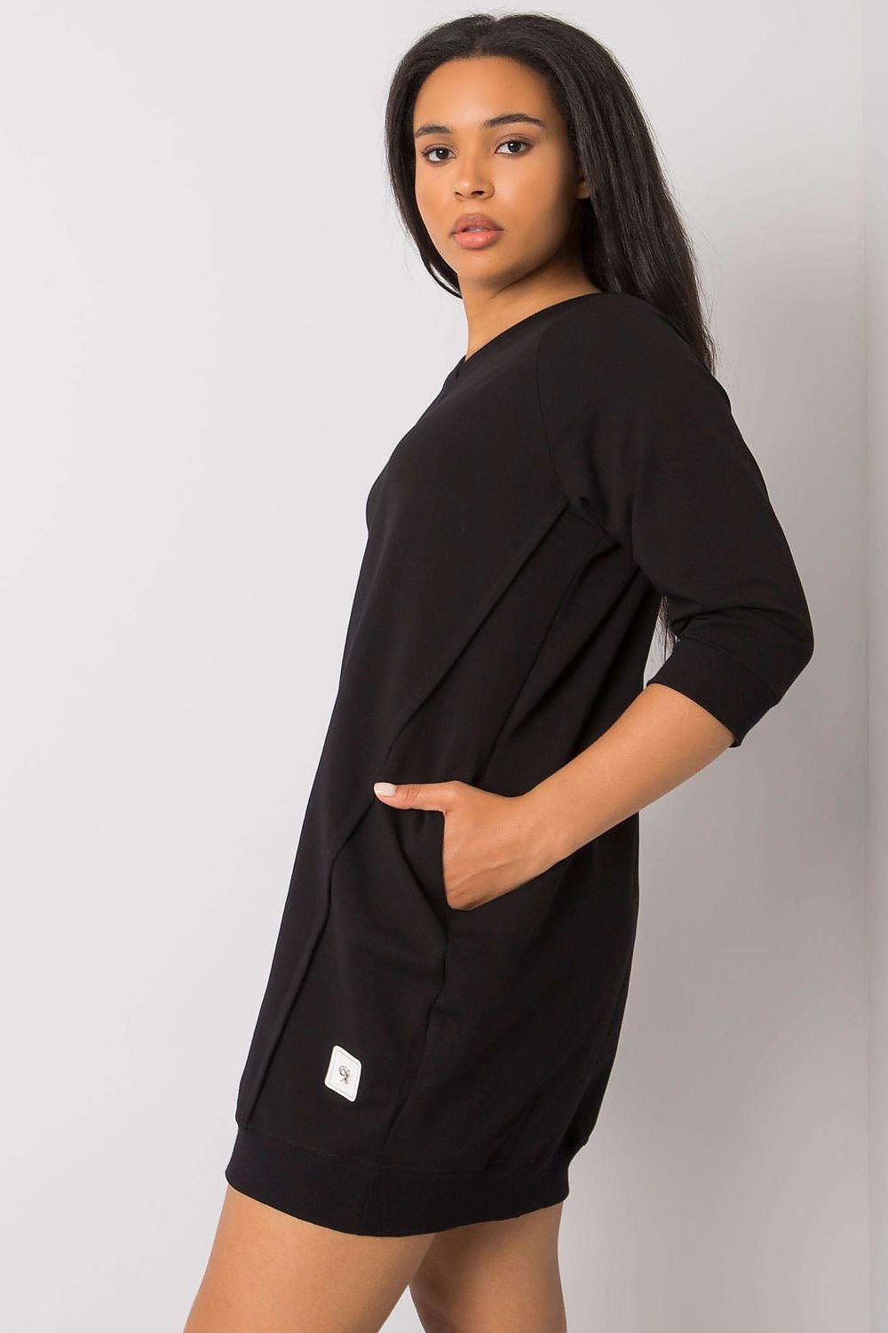 Woman wearing the Plus Size Velissia Cotton Pocket Dress with 3/4 sleeves, showcasing side pockets for functional elegance.