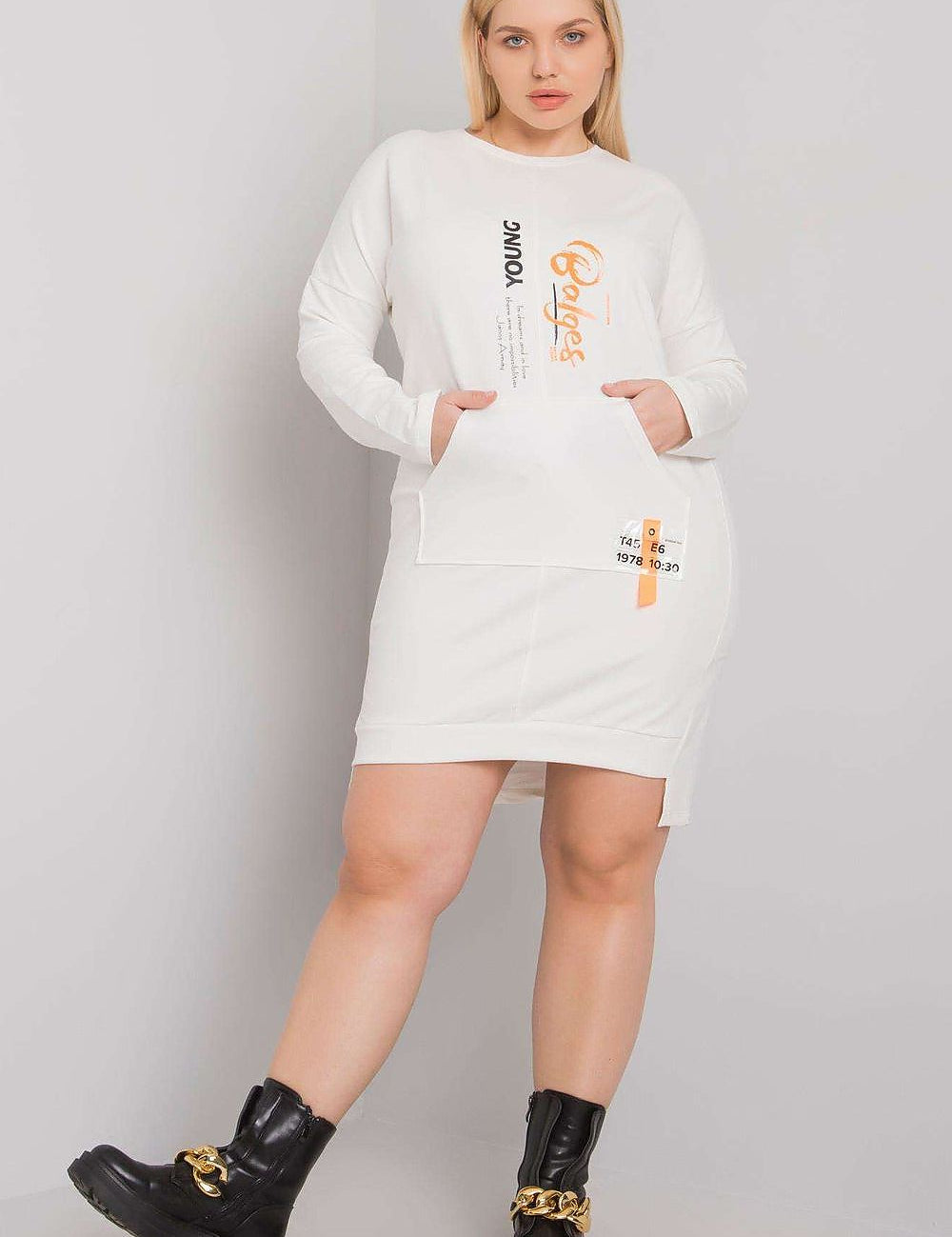 Plus Size Erelvine Pocket Day Dress in white with long sleeves, front pocket, and casual fit, worn by model with black boots.