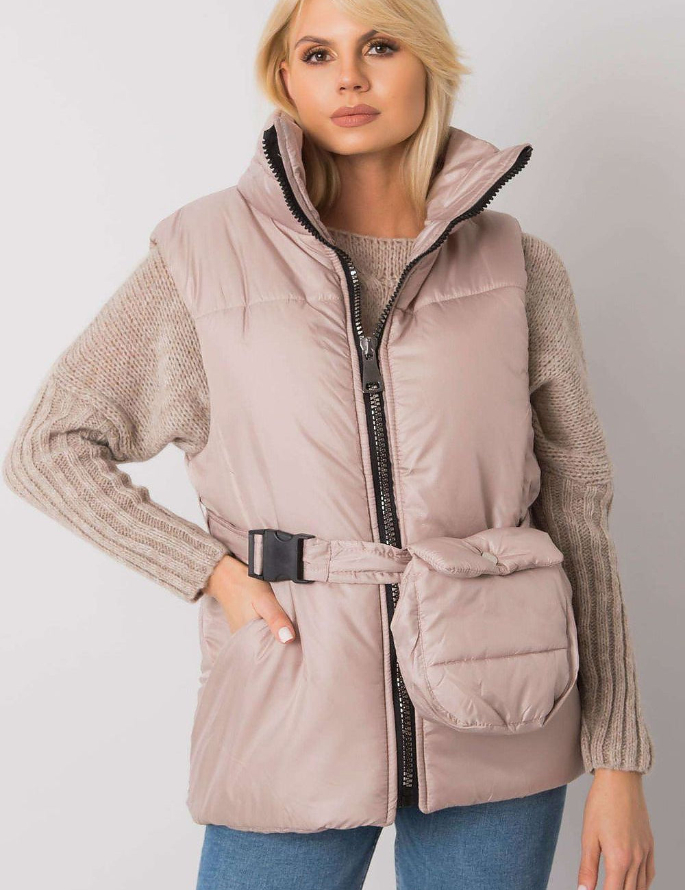 Woman wearing Calveris Belted Lined Zip Gilet in beige, featuring a front zip, side pockets, and coordinating belt over a sweater.