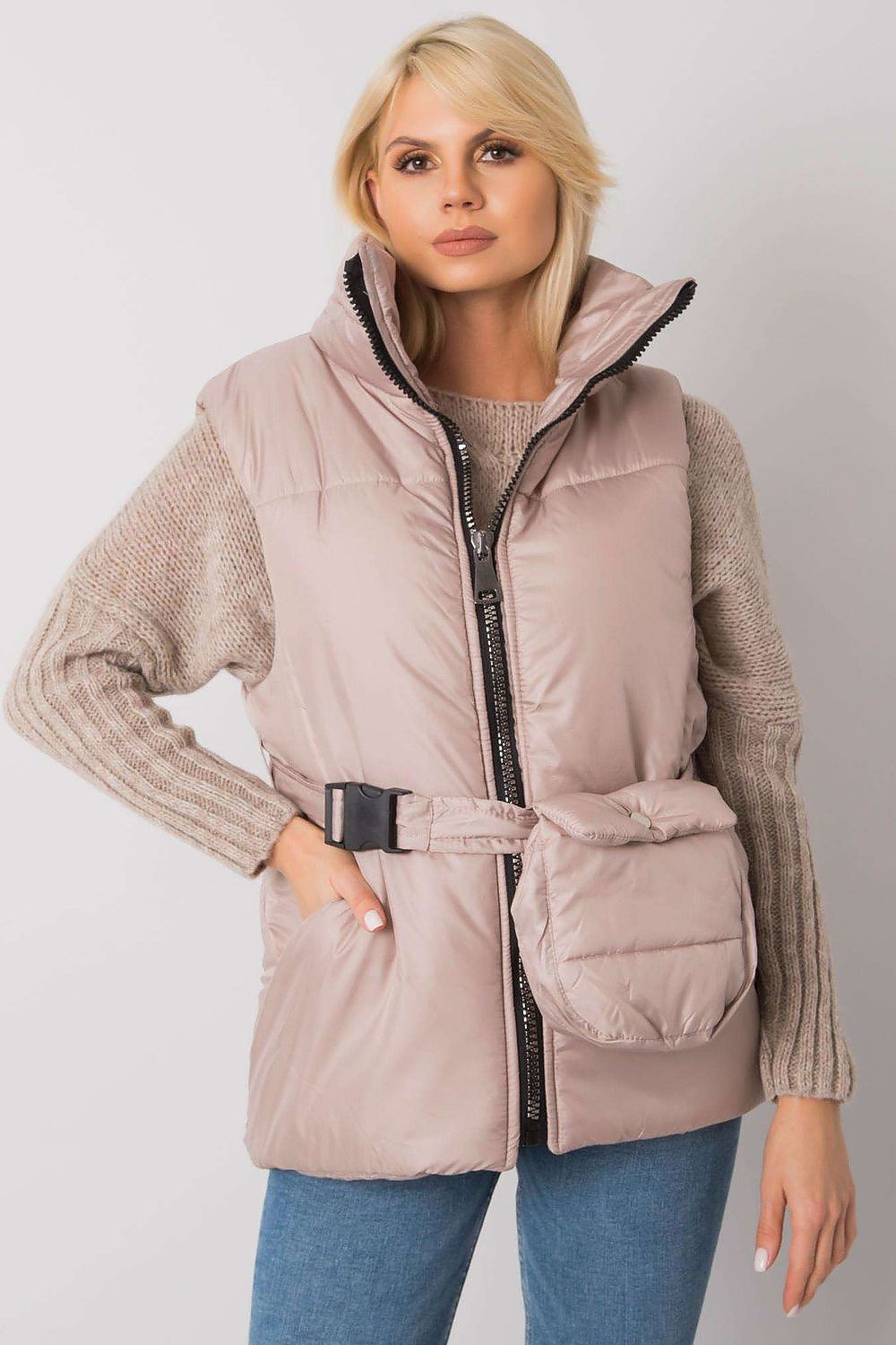 Woman wearing Calveris Belted Lined Zip Gilet in beige, featuring a front zip, side pockets, and coordinating belt over a sweater.