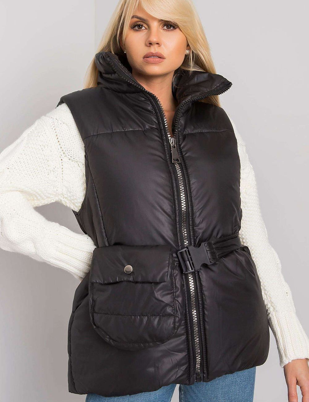 Woman wearing Calveris Belted Lined Zip Gilet, black down-style vest with pockets and coordinating belt, perfect for layering.