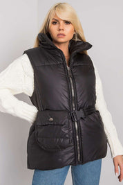 Woman wearing Calveris Belted Lined Zip Gilet, black down-style vest with pockets and coordinating belt, perfect for layering.