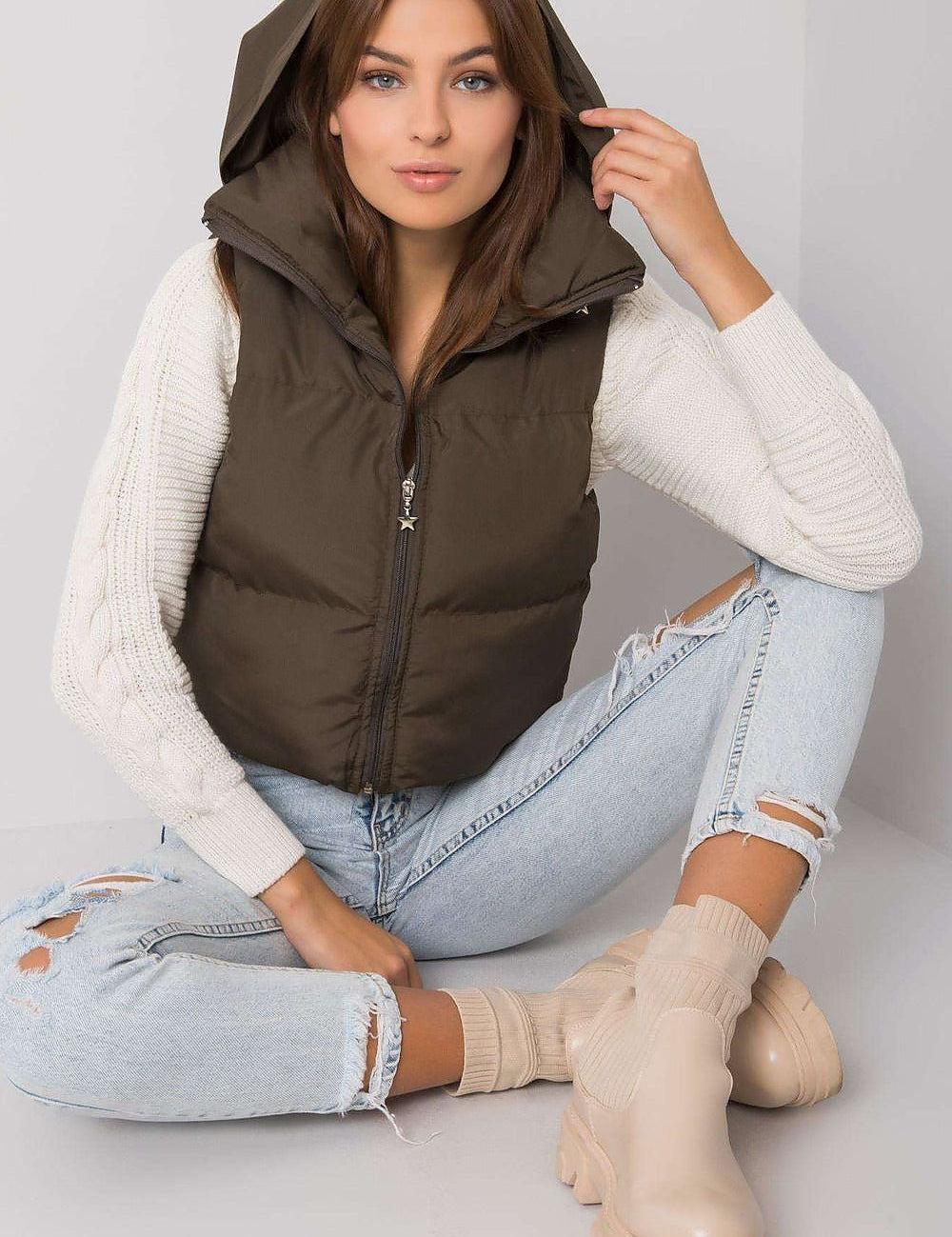 Woman wearing Trevano Khaki Zip Vest with concealed hood, showcasing its lightweight, versatile design for casual and outdoor looks.