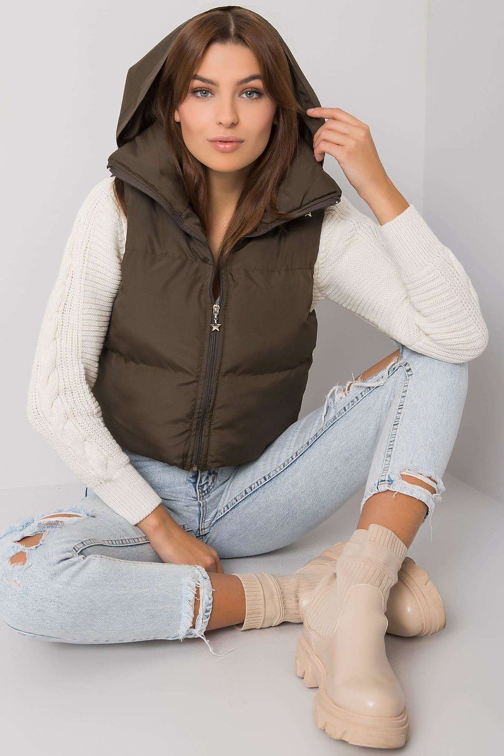 Woman wearing Trevano Khaki Zip Vest with concealed hood, showcasing its lightweight, versatile design for casual and outdoor looks.