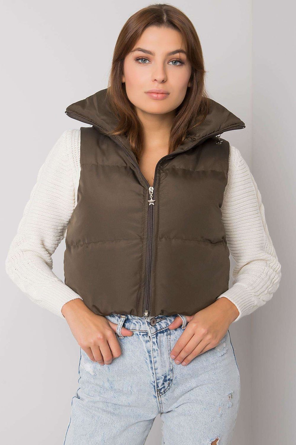 Woman wearing Trevano Khaki Zip Vest with concealed hood, smooth zip closure, perfect for layering and versatile wear.