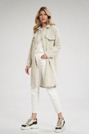 Model wearing Vallerine wool-blend midi coat with decorative patches, buttoned front, side pockets, and classic cuffs.