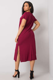 Woman wearing a plus size casual summer dress in red with side slits and short sleeves, showcasing a comfortable and elegant fit.