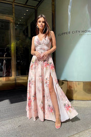 Plus size Fiorenze floral maxi dress with soft neckline and leg slit, worn outdoors for an elegant summer look, city backdrop.