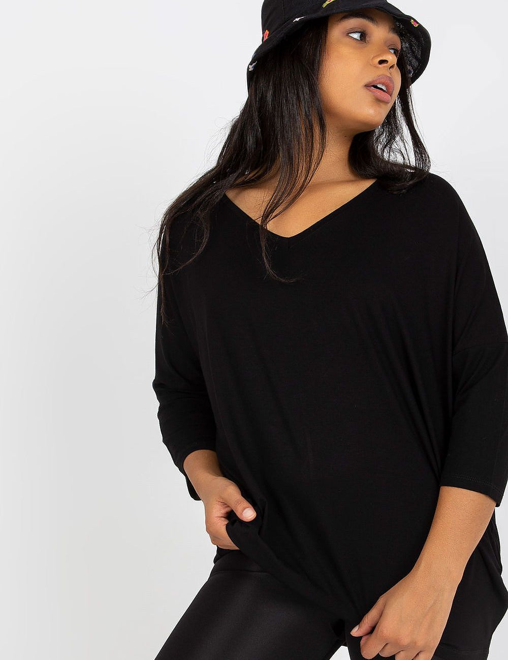 4 sleeve blouse with a sweetheart neckline, paired with leggings and a colorful bucket hat.