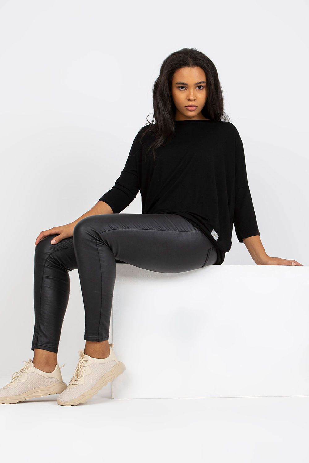 Woman wearing plus size Bellarie cotton blouse in black, with 3/4 sleeves, showcasing a relaxed style for comfort and elegance.