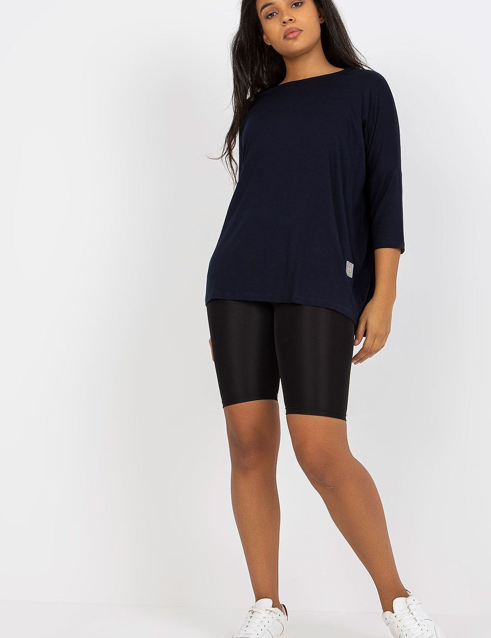 4 sleeves and boat neckline, paired with black shorts and white sneakers.