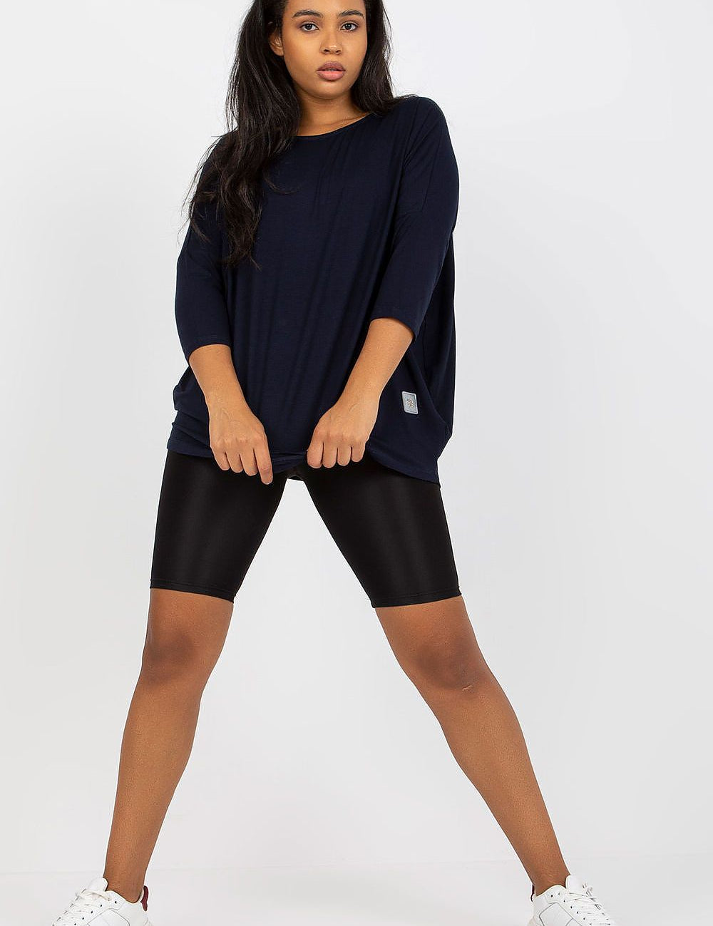 4 sleeves, paired with black leggings, showcasing casual style and comfort.