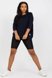 Woman wearing Plus Size Bellarie Cotton Blouse, relaxed fit with 3/4 sleeves, paired with black leggings, showcasing casual style and comfort.