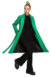 Model wearing Alvenora Belted Fleece Long Coat in green with classic collar, large pockets, and belt, showcasing its stylish design.