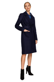 Woman wearing Alvenora belted fleece long coat with large patch pockets, classic collar, and straight silhouette, in a stylish pose.