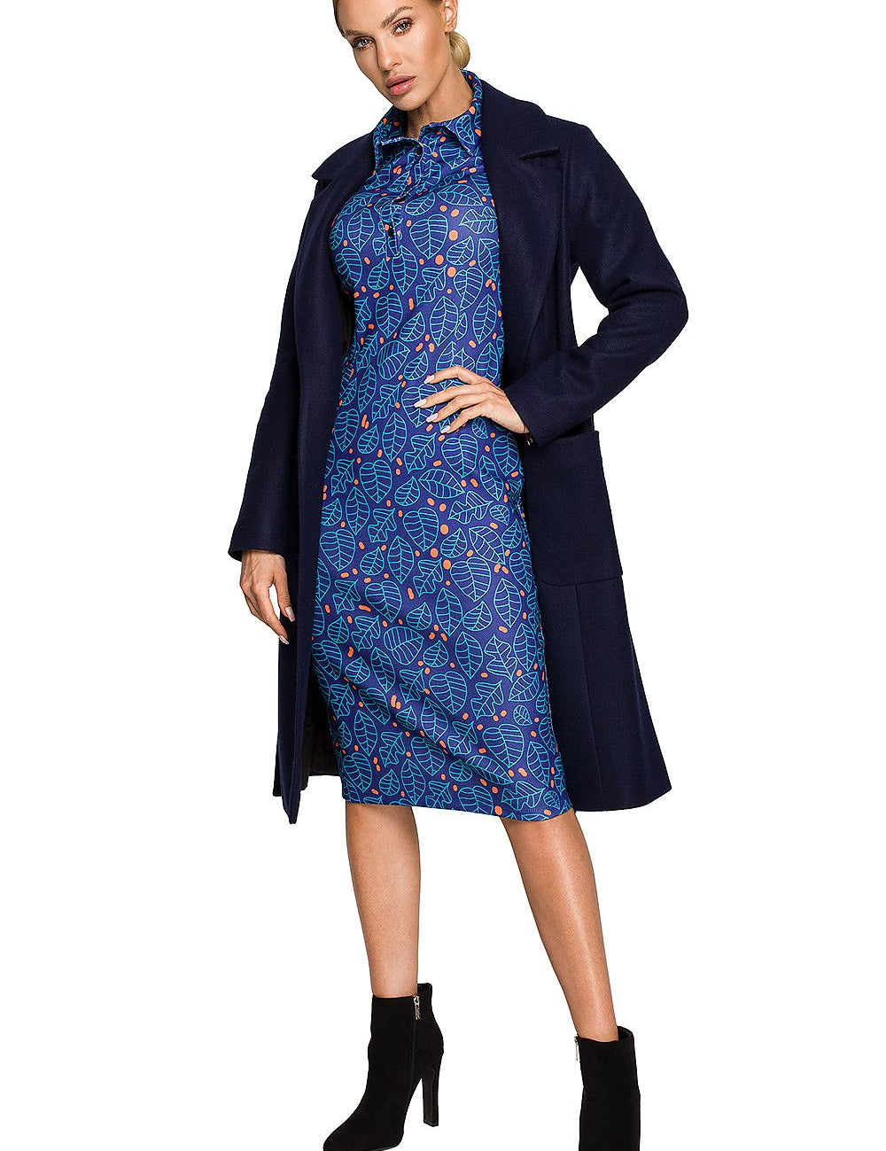 Model wearing Alvenora Belted Fleece Long Coat over blue patterned dress, highlighting classic collar and waist-tie belt.