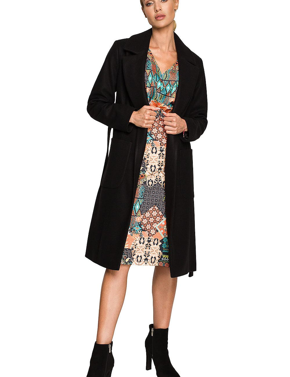 Woman wearing Alvenora Belted Fleece Long Coat with classic collar, patch pockets, and waist tie, styled over a colorful patterned dress.