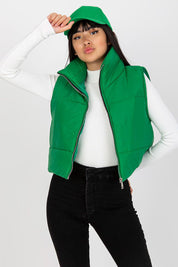 Model wearing green Irdena Insulated Quilted Gilet Vest with zippered front, styled for casual city look.