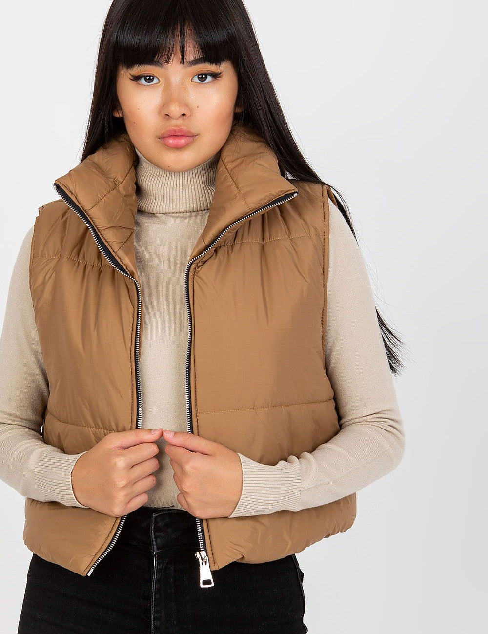 Woman wearing Irdena Insulated Quilted Gilet Vest, short quilted design, zippered front, styled for casual city fashion.