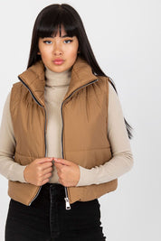 Woman wearing Irdena Insulated Quilted Gilet Vest, short quilted design, zippered front, styled for casual city fashion.