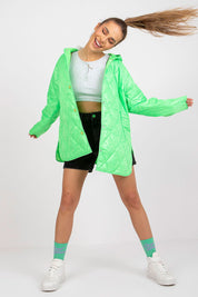 Woman wearing Serentha Hooded Quilted Jacket in bright green, styled with casual shorts and sneakers for a modern, dynamic look.