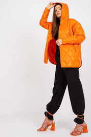 Woman wearing Serentha Hooded Quilted Jacket in orange, featuring a cozy hood and sleek design, perfect for transitional layering.