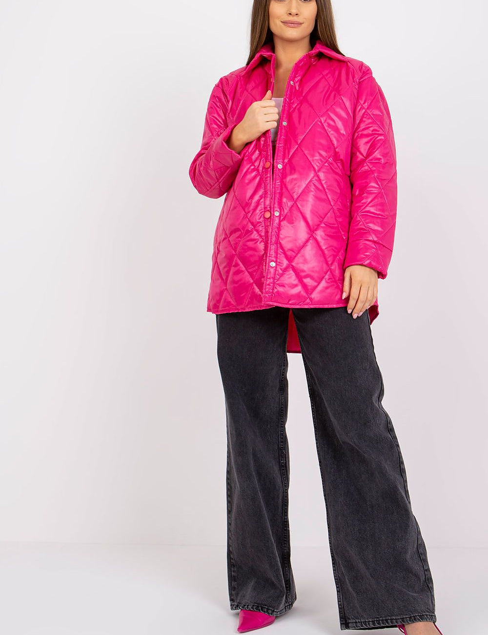 Model wearing Cerenya Quilted Jacket with Extended Back in pink, showcasing quilted pattern, side slip pockets, and a stylish silhouette.