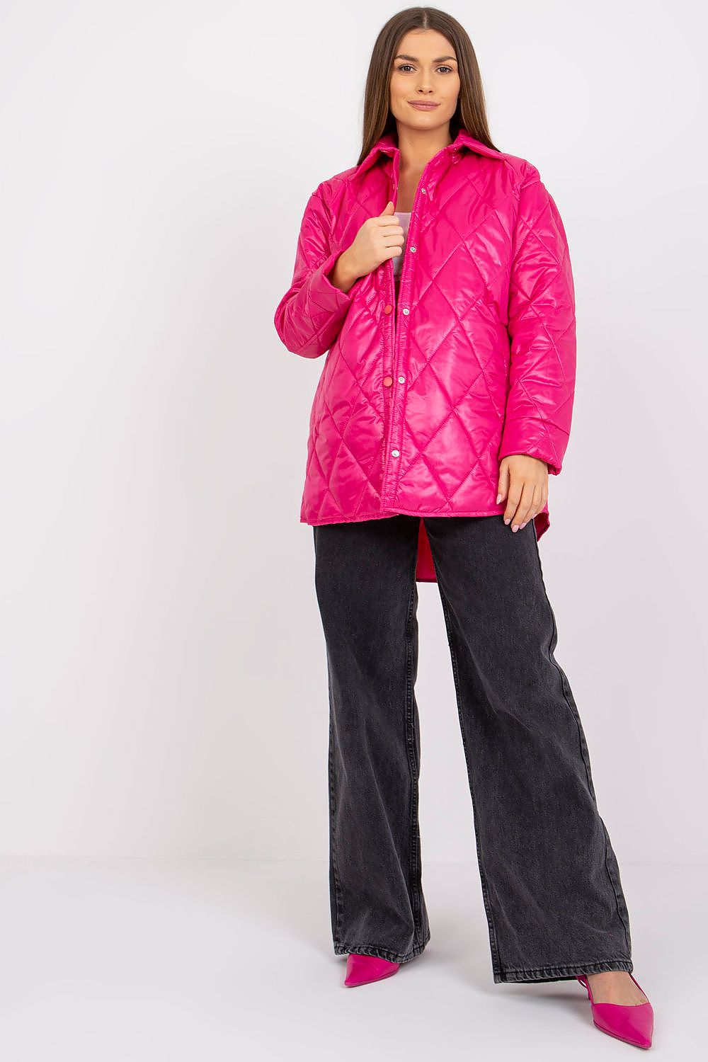 Model wearing Cerenya Quilted Jacket with Extended Back in pink, showcasing quilted pattern, side slip pockets, and a stylish silhouette.