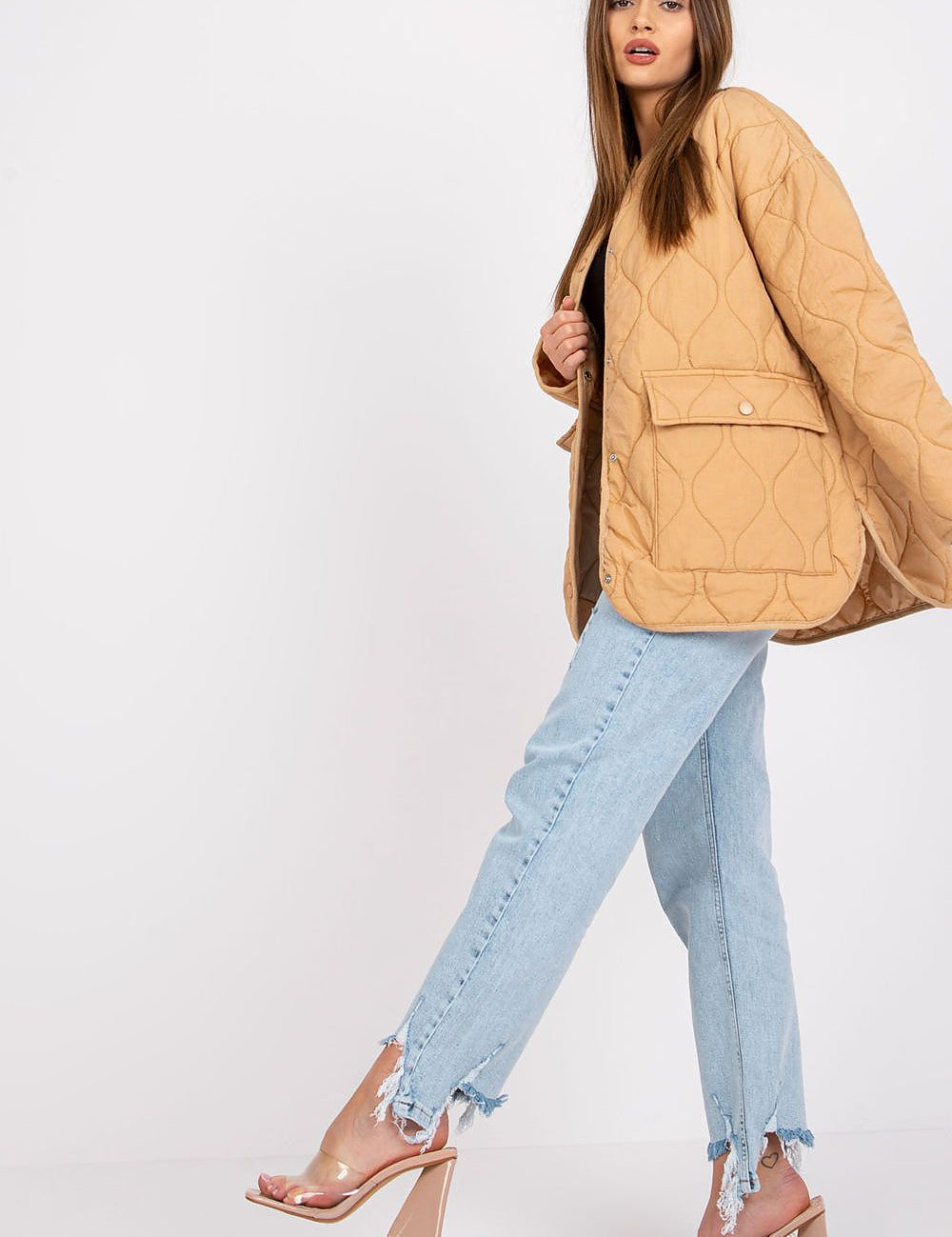 Model wearing Elenique quilted jacket with press studs, showcasing its lightweight design and elegant silhouette.