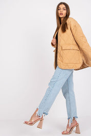 Model wearing Elenique quilted jacket with press studs, showcasing its lightweight design and elegant silhouette.