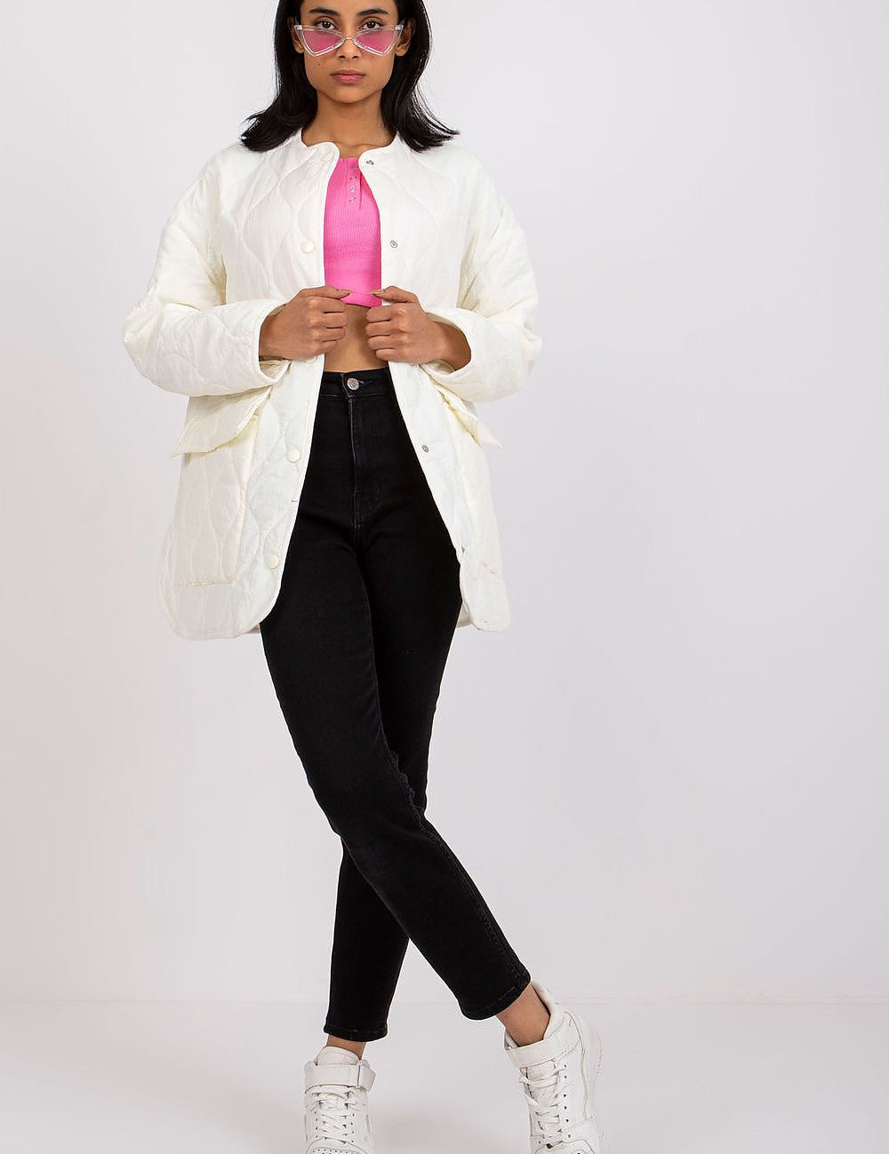 Model wearing Elenique Quilted Jacket with press studs, styled with pink top, black jeans, and white sneakers.