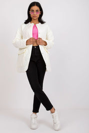 Model wearing Elenique Quilted Jacket with press studs, styled with pink top, black jeans, and white sneakers.