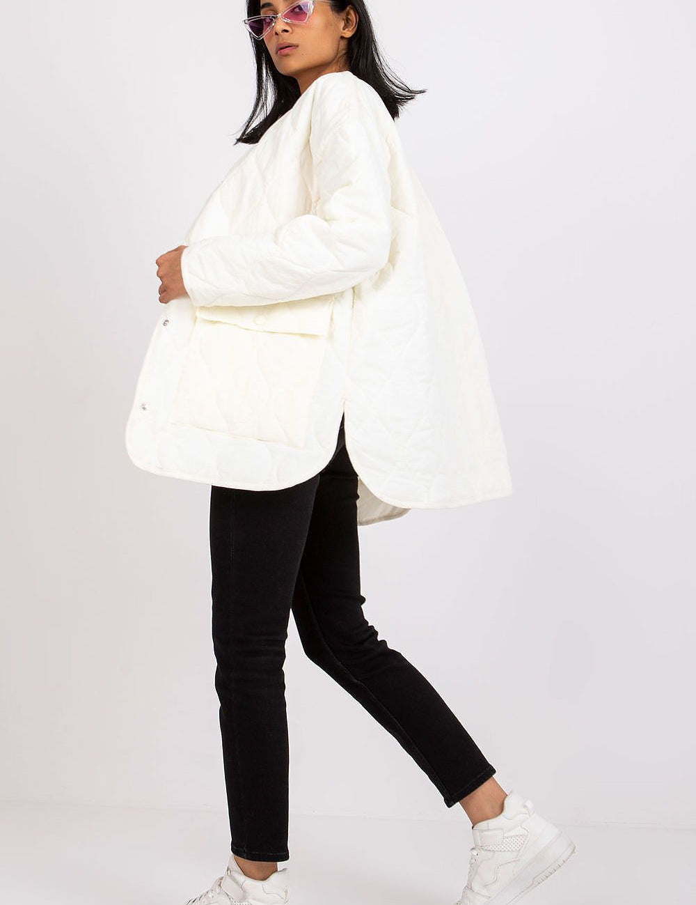 Woman wearing Elenique Quilted Jacket with Press Studs, showcasing long sleeves and spacious pockets for transitional seasons.