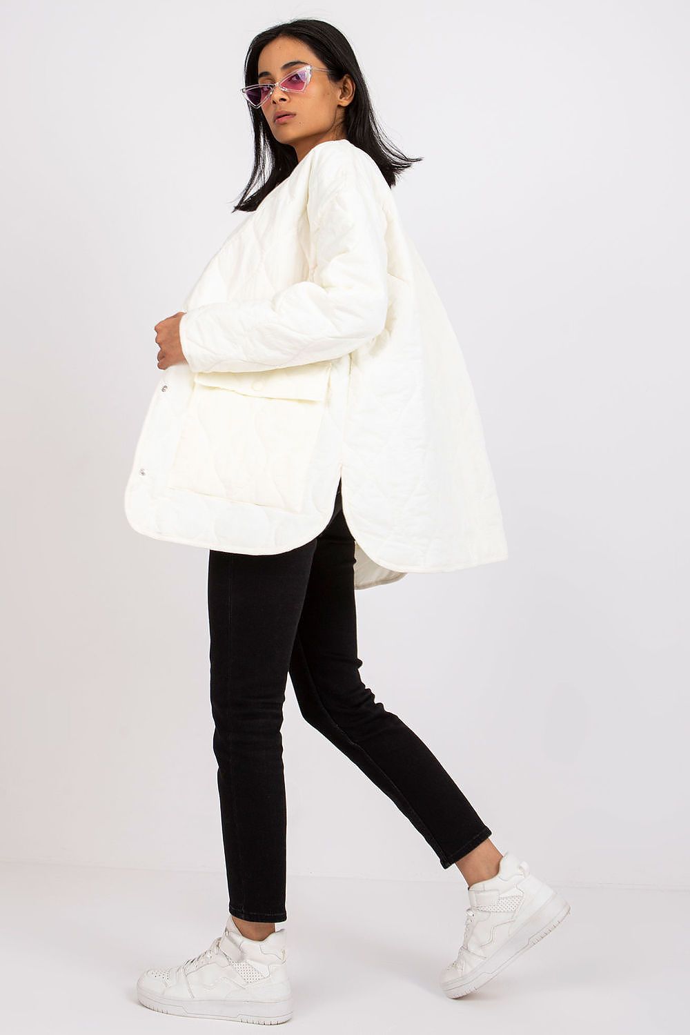 Woman wearing Elenique Quilted Jacket with Press Studs, showcasing long sleeves and spacious pockets for transitional seasons.