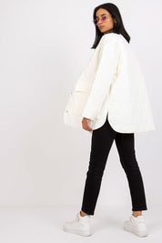 Model wearing Elenique lightweight quilted jacket with press studs, styled for effortless elegance in mild weather.