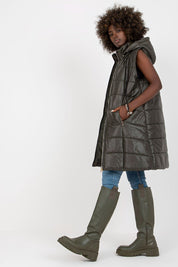 Woman wearing Evrendelle Quilted Longline Vest with detachable hood, showcasing sleek silhouette and practicality for transitional seasons.